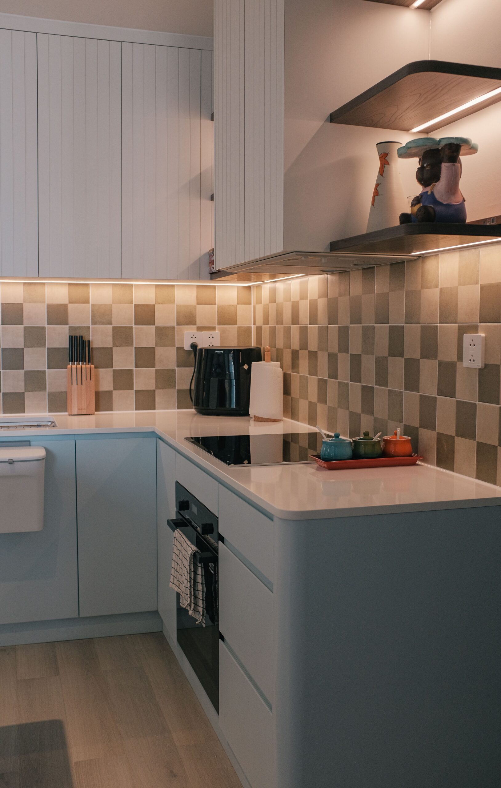 A stylish and modern kitchen with minimalistic decor and elegant lighting.